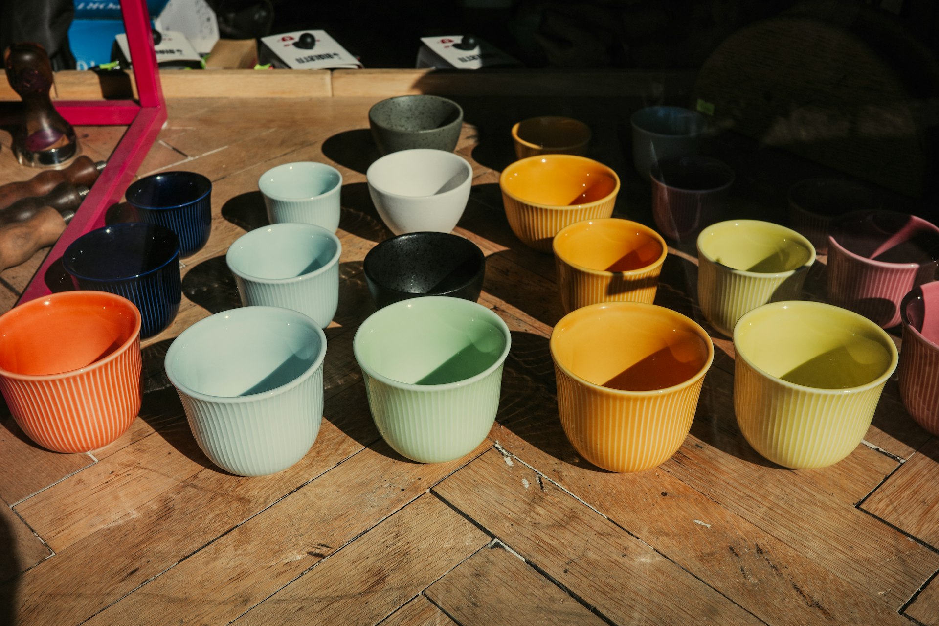 A group of cups sitting on top of a wooden table
